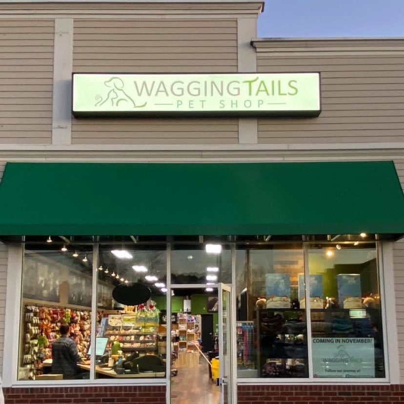 https://www.waggingtailspetshop.com/hubfs/Front%20of%20Store%20sign%20lighted.jpg